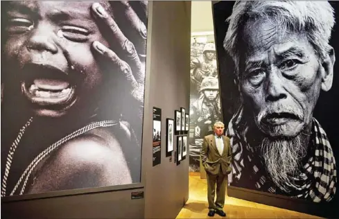  ?? LEON NEAL/AFP ?? British photograph­er Don McCullin stands among some of his featured photos at the in London in 2011.