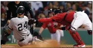  ?? AP/MICHAEL DWYER ?? Boston Red Sox’s Christian Vazquez (right) tags out New York Yankees’ Gary Sanchez (24), who tried score on a single by Brett Gardner during the seventh inning Friday in Boston.