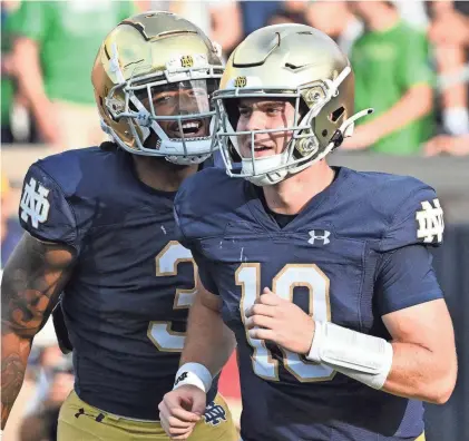  ?? MATT CASHORE/USA TODAY SPORTS ?? Notre Dame Fighting Irish running back Gi'Bran Payne (3) celebrates with quarterbac­k Steve Angeli (18) after a touchdown pass against the Tennessee State Tigers on Sep 2, 2023.