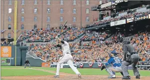  ?? AP PHOTO ?? Baltimore Orioles’ Mark Trumbo, centre, watches his solo home run in front of Toronto Blue Jays catcher Russell Martin and home plate umpire Gary Cederstrom in the 11th inning of an opening day baseball game in Baltimore Monday. Baltimore won 3-2 in 11...