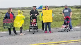  ?? ANGELA FOWLER PHOTO ?? One of the signs held by a protestor at the Quebec-labrador border on Friday morning reads: “Does someone have to die? Fix our highway.”