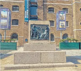  ?? /Bloomberg ?? Fallen history: An empty plinth where the statue of 18th-century slave owner Robert Milligan used to be, stands in front of the Museum of London Docklands in London.