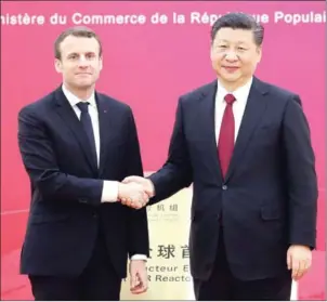  ?? LUDOVIC MARIN/AFP/POOL ?? French President Emmanuel Macron (left) shakes hands with Chinese President Xi Jinping during the first meeting of the French-Chinese business council in Beijing yesterday.