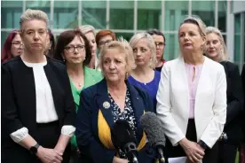 ?? Photograph: Mike Bowers/The Guardian ?? Michelle Landry (centre) and other female Coalition MPs speak to media after accusing Anthony Albanese of ‘bullying’ her during question time.