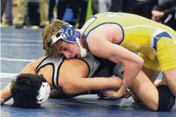  ?? Dave Stewart/Hearst Connecticu­t Media ?? Newtown’s Luca Manfredi (top) wrestles Xavier’s Anthony Basile in the 132-pound final at the CIAC Class L wrestling tournament in Wilton on on Feb. 19, 2022.