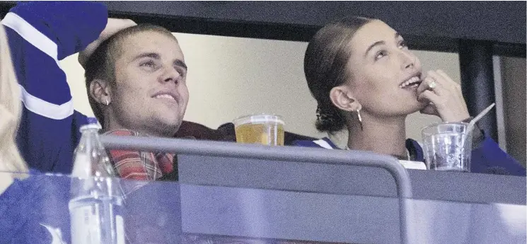  ?? CHRIS YOUNG/THE CANADIAN PRESS ?? Canadian pop star Justin Bieber and his wife, model Hailey Baldwin, attend a Leafs game in Toronto in November. Lawyers say there are still options for couples like Bieber and Baldwin, who didn’t sign a pre-nuptial agreement — a post-nup can be signed before or after a wedding that can be a “security blanket” or help safeguard their wealth.