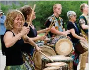  ??  ?? The Sehwe Village Percussion ensemble plays during the Decatur Arts Festival in downtown Decatur.