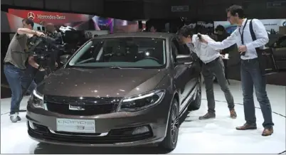  ?? WANG SIWEI / XINHUA ?? Qoros unveils its first series of models at the Geneva auto show in March last year, aiming at discerning young buyers in China and Europe.