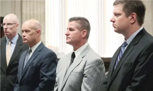  ?? ANTONIO PEREZ /CHICAGO TRIBUNE POOL PHOTO ?? Chicago Police Officer Jason Van Dyke (from right) stands before the judge Friday with defense attorney Daniel Herbert, special prosecutor Joe McMahon and assistant special prosecutor Joseph Cullen at the Leighton Criminal Court Building.