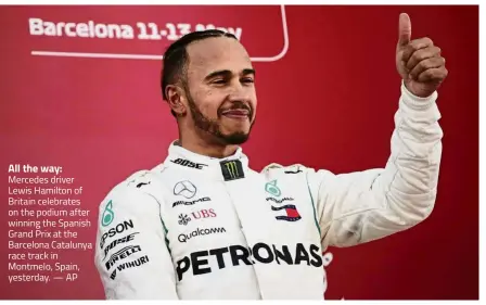  ??  ?? All the way: Mercedes driver Lewis Hamilton of Britain celebrates on the podium after winning the Spanish Grand Prix at the Barcelona Catalunya race track in Montmelo, Spain, yesterday. — AP