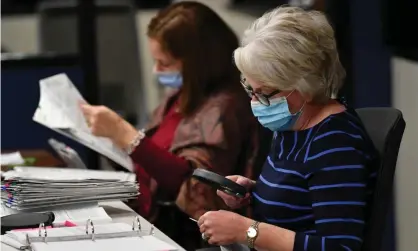  ??  ?? Officials count ballots at the Mecklenbur­g county board of elections office in Charlotte, North Carolina, on 6 November. Photograph: Anadolu Agency/Getty Images
