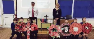  ??  ?? Rishton Methodist Primary School pupils with handmade poppy wreaths which they later took to the war memorial