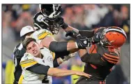  ?? AP/DAVID RICHARD ?? Cleveland Browns defensive end Myles Garrett (95) hits Pittsburgh Steelers quarterbac­k Mason Rudolph with a helmet Thursday in Cleveland.