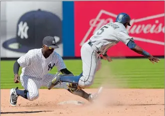  ?? BILL KOSTROUN/AP PHOTO ?? Mariners pinch runner Guillermo Heredia (5) is caught stealing as he is tagged out by Yankees shortstop Didi Gregorius (18) during the eighth inning of Thursday’s game at New York.