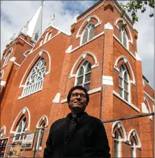  ?? JASON FRANSON/The Canadian Press ?? Father Cristino Bouvette outside Scared Heart Church in Edmonton earlier this summer. Father Bouvette, 36, a priest of mixed Italian, Metis and Cree heritage, will be the national liturgical director for the papal visit from July 24 to 29.