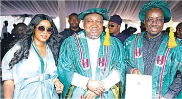  ?? ?? Enugu State governor, Lawrence Ifeanyi Ugwuanyi ( middle); Dr. Obinna Iyiegbu ( a. k. a Obi Cubana) and his wife, Ebele Iyiegbu ( left) after the Enugu State University of Science and Technology conferred the Doctor of Business s
Administra­tion on Iyiegbu, recently.