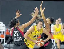  ?? AP ?? Seattle Storm forward Breanna Stewart gets between Las Vegas Aces center A'ja Wilson and forward Cierra Burdick during Tuesday night’s game.