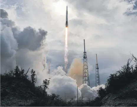  ?? AP ?? Companies such as SpaceX, seen here launching a Falcon 9 rocket from Cape Canaveral, have helped to drive down launch costs