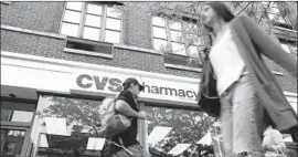  ?? Spencer Platt Getty Images ?? CVS switched its 200,000 workers and their families to high-deductible plans about five years ago and then realized workers were cutting back on medication­s.