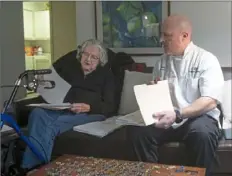  ??  ?? Chef Matt Rice consults with his client, Betty Reese, as she selects entrees from a menu at her home in O'Hara.