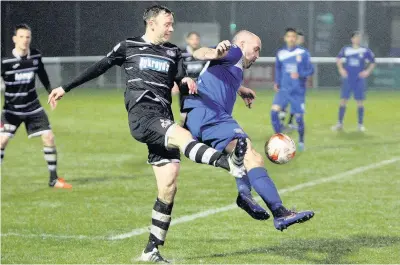  ?? Picture: Richard Birch ?? Bangor City’s Gary Taylor-Fletcher (blue) keeps control of this ball against Bala