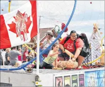  ?? DESIREE ANSTEY JOURNAL PIONEER ?? Lennox Island Councillor Janet Bernard hands out candy with helpers on the dream catcher float.