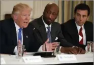  ??  ?? President Donald Trump, left, speaks during a meeting with manufactur­ing executives at the White House in Washington, including Merck CEO Kenneth Frazier, center, and Ford CEO Mark Fields.