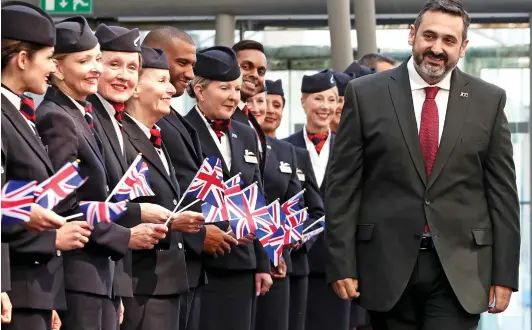  ??  ?? Flag carriers: BA chief executive Alex Cruz with cabin crew. He told them yesterday the airline will have to lay off workers