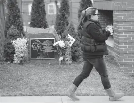  ?? JULIO CORTEZ/THE ASSOCIATED PRESS ?? A memorial, left, honouring comfort women of the Second World War stands at a distance while a woman walks to an adjacent library recently in Palisades Park, N.J.