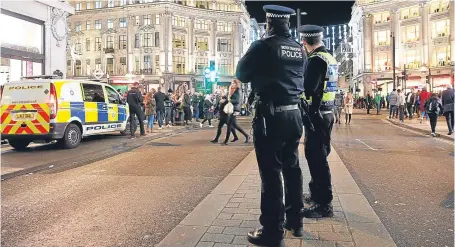  ?? Picture: AP. ?? Police officers and vehicles near Oxford Circus station in London after it was reopened.