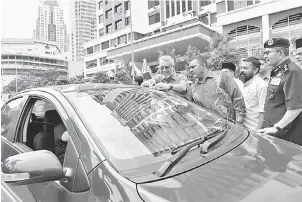  ?? — Gambar Bernama ?? KIBAR JALUR GEMILANG: Khalid (kiri) bersama Mazlan (kanan) dan Jawahir (dua kiri) memasang Jalur Gemilang pada sebuah kenderaan awam ketika Majlis Penyerahan Jalur Gemilang Sempena Bulan Kemerdekaa­n 2018 anjuran bersama Polis Diraja Malaysia (PDRM), Dewan Bandaraya Kuala Lumpur (DBKL) dan di Ibu Pejabat Daerah Dang Wangi semalam.