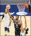  ??  ?? Minnesota Lynx center Sylvia Fowles (34) scores on a layup while defended by Dallas Wings forward Charli Collier (35) during the first half in a WNBA basketball game, on July 7, in Minneapoli­s. (AP)
