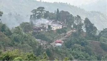  ?? — AFP file photos ?? A burning Myanmar military building amid clashes with ethnic minority armed group Ta’ang National Liberation Army (TNLA) in Namhsan Township in Myanmar’s northern Shan State.