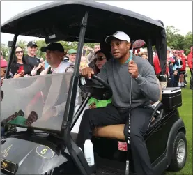  ?? ?? Tiger Woods using a kart to get around Adare Manor yesterday