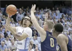  ?? AP photo ?? North Carolina guard Cole Anthony drives to the basket against Notre Dame’s Rex Pflueger during the first half of the Tar Heels’ 76-65 win Wednesday.