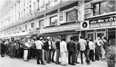  ??  ?? AFTER NOTE BAN People lined up outside an ATM to draw money following demonetisa­tion last year. Withdrawin­g currency notes is a temporary measure to curb black money and corruption