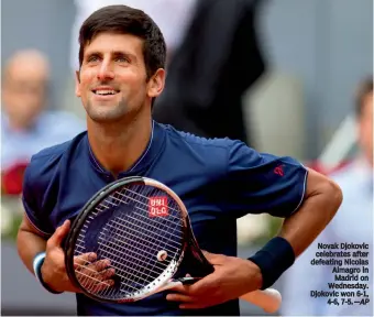  ??  ?? Novak Djokovic celebrates after defeating Nicolas Almagro in Madrid on Wednesday. Djokovic won 6-1, 4-6, 7-5.—AP
