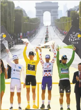  ?? Stephane Mantey / Associated Press ?? The Tour de France winners stand with the Arc de Triomphe behind them. From left: Pierre Roger Latour (best young rider), Geraint Thomas (overall winner), Julian Alaphilipp­e (best climber) and Peter Sagan (best sprinter).