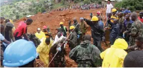  ?? (Reuters) ?? RESCUE WORKERS search for survivors after a mudslide in the Mountain town of Regent, Sierra Leone, on Monday.