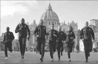  ?? Associated Press photo/Andrew Medichini ?? Athletes of the Athletic Vatican sports team run for the media in front of St. Peter’s basilica, at the Vatican, Thursday.