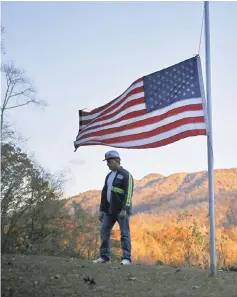  ??  ?? An unemployed coal miner stands for a portrait in the front yard of his Harlan County home in Baxter, Kentucky, in 2013. — Photos by Luke Sharrett.