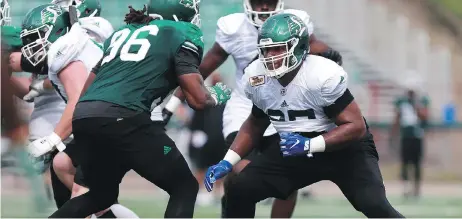  ?? MICHELLE BER ?? Terran Vaughn, right, is the likeliest candidate to start at left offensive tackle for the Saskatchew­an Roughrider­s.