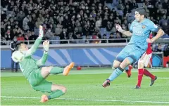  ?? AP ?? Barcelona’s Luis Suarez scores past Guangzhou goalkeeper Li Shuai.