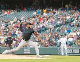  ?? JUSTIN EDMONDS/GETTY ?? Marlins starting pitcher Edward Cabrera delivers to home plate in the sixth inning against the Rockies on Wednesday in Denver.