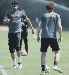  ??  ?? Chelsea striker Diego Costa gets down to work in training (left), while Cesc Fabregas (right) was more relaxed ahead of the Emirates FA Cup Final.