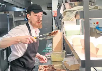  ??  ?? Grosvenor Casino Dundee chef Sean McDonald busy preparing some of the free lunches for emergency workers and the vulnerable. Picture by Dougie Nicolson.