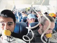  ?? MARTY MARTINEZ THE ASSOCIATED PRESS ?? Marty Martinez, left, is photograph­ed with other passengers on a Southwest Boeing 737 after an engine blew out on Tuesday.