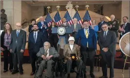  ?? MARK SCHIEFELBE­IN — THE ASSOCIATED PRESS ?? Ghost Army members John Christman, of Leesburg, N.J., second from left standing; Seymour Nussenbaum, of Monroe Township, N.J, in wheelchair at left; and Bernard Bluestein, of Hoffman Estates, Ill., in wheelchair at right, join officials as members of their secretive WWII-ERA unit are presented with the Congressio­nal Gold Medal on Thursday.