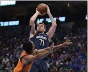  ?? TONY GUTIERREZ — THE ASSOCIATED PRESS ?? Phoenix Suns guard Cameron Payne defends as Dallas Mavericks guard Luka Doncic (77) takes a shot in the second half of Game 4 of an NBA basketball second-round playoff series, Sunday in Dallas.