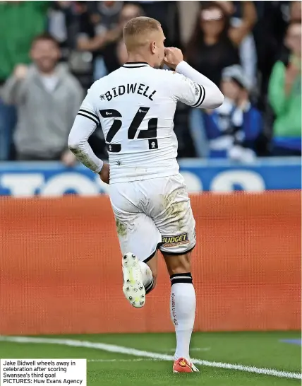  ?? ?? Jake Bidwell wheels away in celebratio­n after scoring Swansea’s third goal PICTURES: Huw Evans Agency